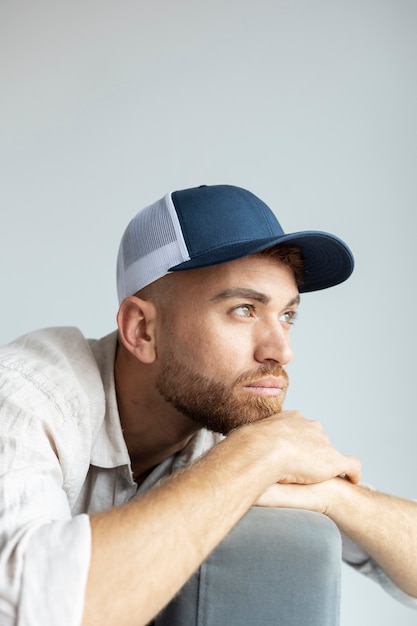 Free Photo medium shot man posing with trucker hat