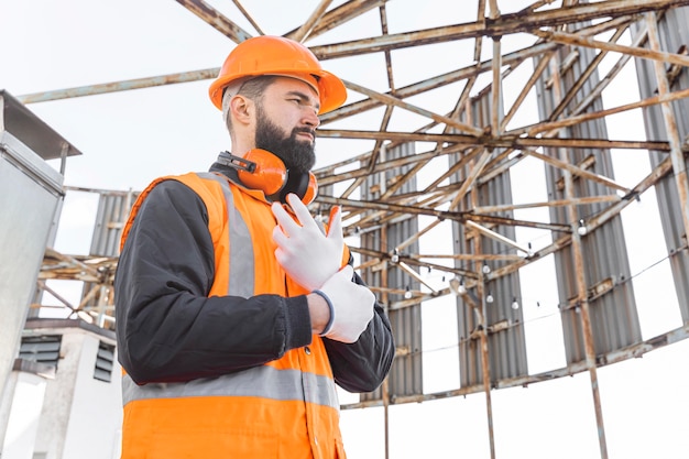 Free photo medium shot man putting on gloves for work