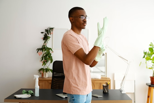 Medium shot man putting on gloves