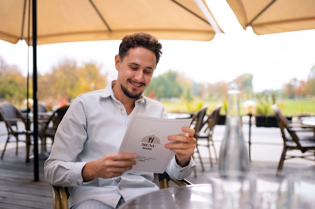 Medium shot man reading menu