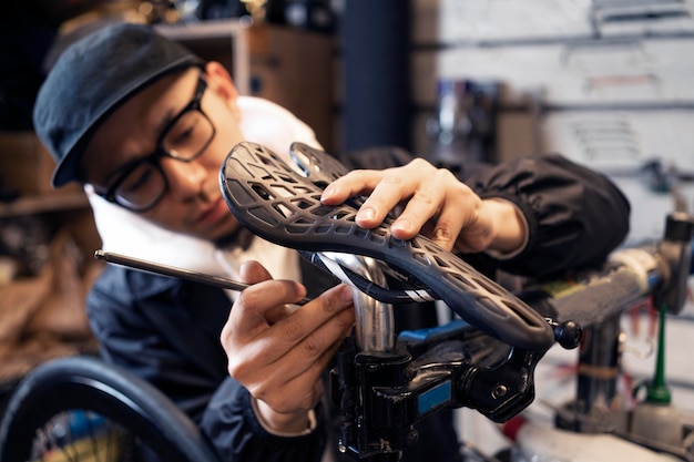 Medium shot man repairing bike in shop