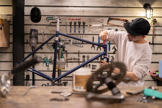 Free Photo medium shot man repairing bike