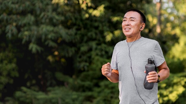 Medium shot man running in park