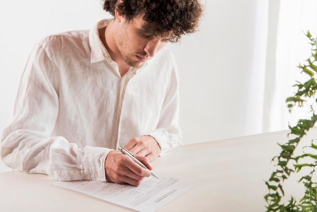 Medium shot man signing document