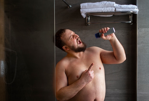 Medium shot man singing in shower