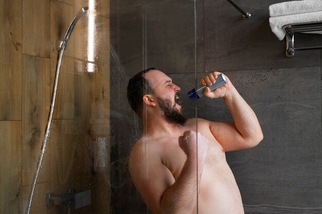 Medium shot man singing in shower