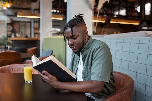 Medium shot man sitting in coffee shop