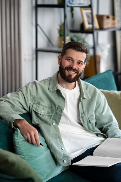 Free Photo medium shot man sitting indoors