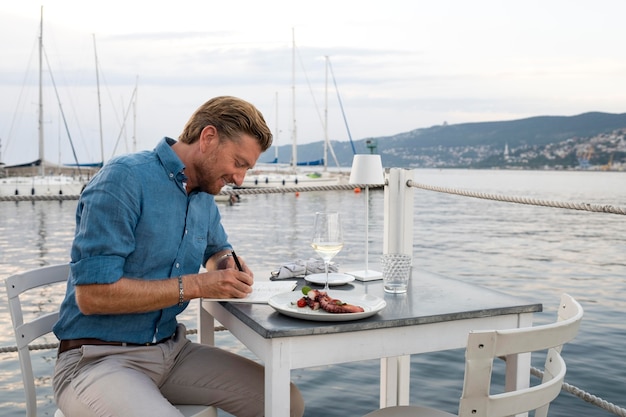 Free photo medium shot man sitting at table