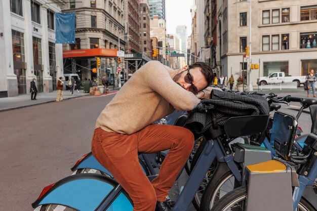 Medium shot man sleeping on bicycle