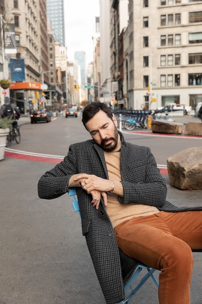 Medium shot man sleeping on chair outdoors