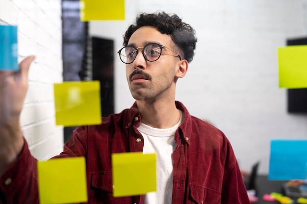 Medium shot man sticking post its