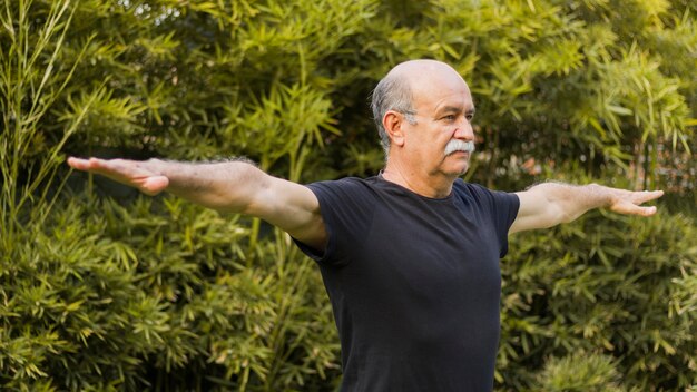 Medium shot of man stretching his arms