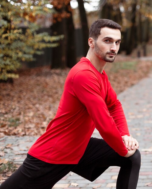 Medium shot man stretching in nature