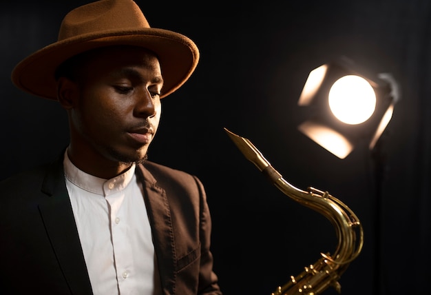 Medium shot man in suit holding saxophone