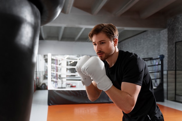 Free Photo medium shot man teaching boxing