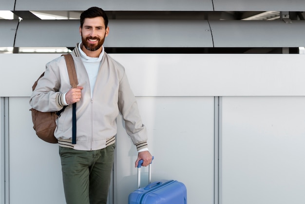 Medium shot man traveling with baggage