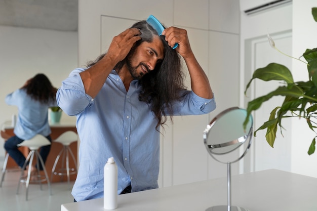 Free photo medium shot man using dry shampoo  at home