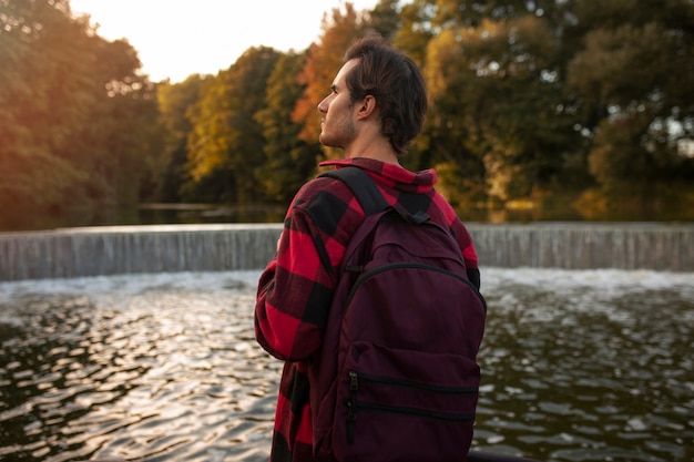 Free Photo medium shot man wearing backpack