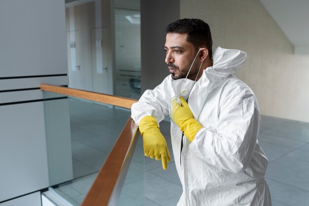 Medium shot man wearing hazmat suit