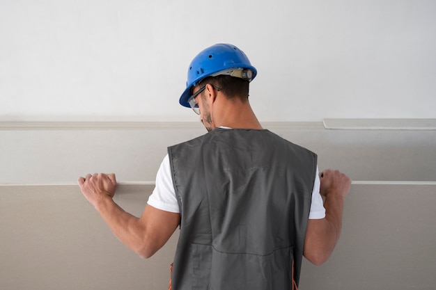 Free Photo medium shot man wearing helmet at job