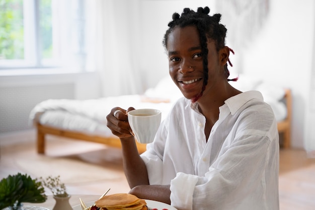 Free photo medium shot man wearing linen clothing at home