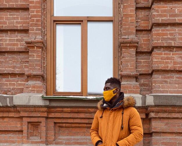 Medium shot man wearing yellow mask