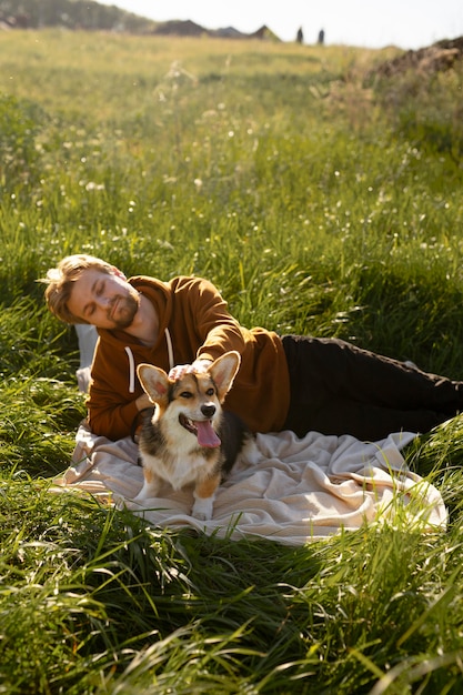 Free Photo medium shot man with dog in nature