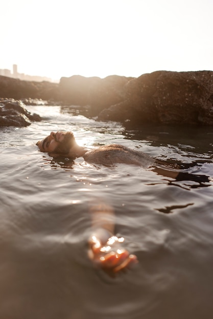 Free photo medium shot man with hairy chest at seaside