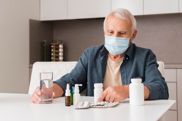 Medium shot man with mask and medicine