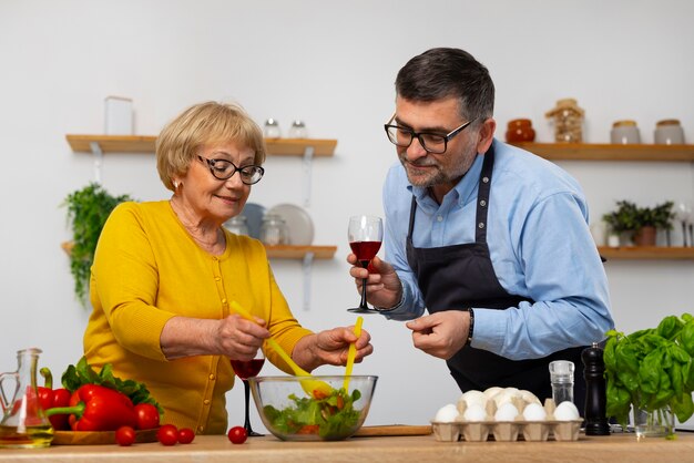 Medium shot man and woman cooking in kitchen