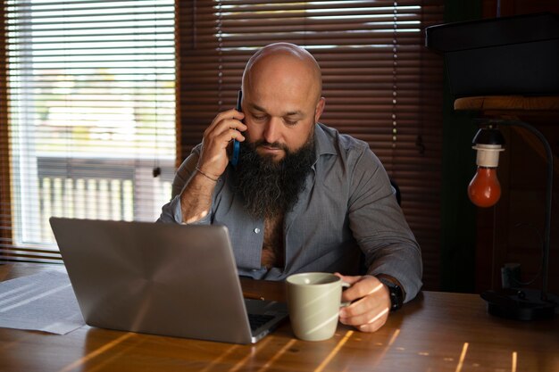 Medium shot man working on laptop