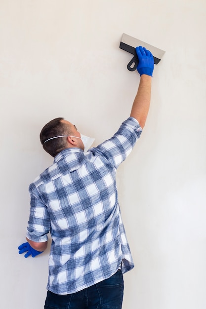 Free Photo medium shot of a man working on a wall