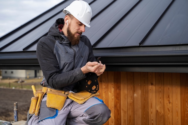 Free photo medium shot man working with helmet