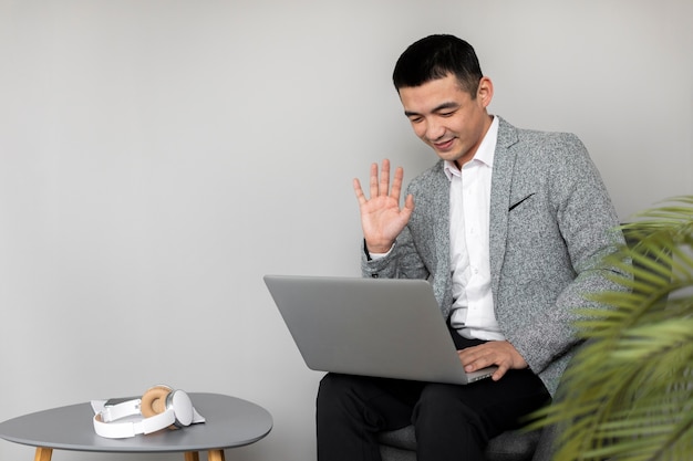 Medium shot man working with laptop