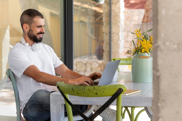 Free Photo medium shot man working with laptop