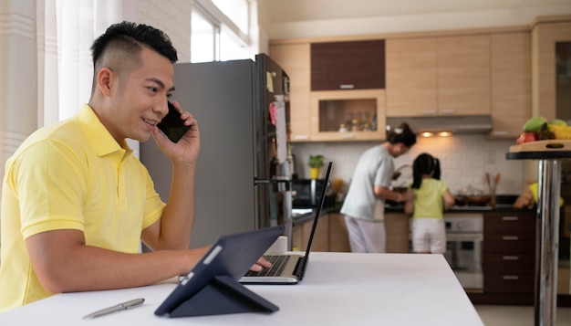 Medium shot man working with laptop