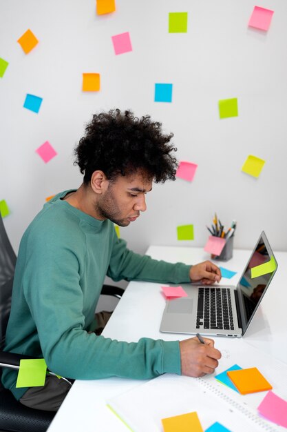 Medium shot man working with laptop