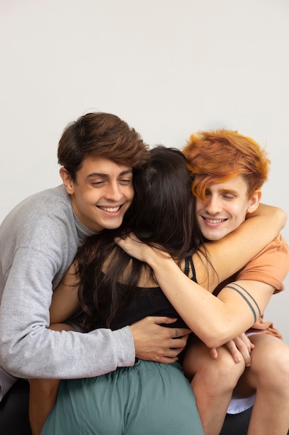 Medium shot men hugging woman