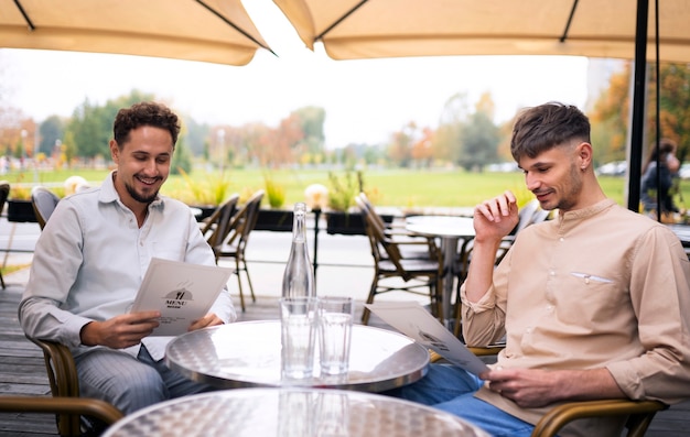 Medium shot men sitting at table