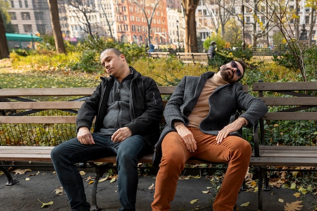 Medium shot men sleeping on bench