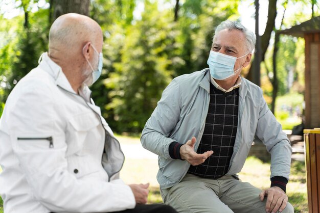 Medium shot men wearing face masks