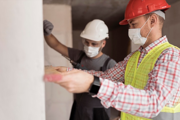 Free Photo medium shot men working with masks