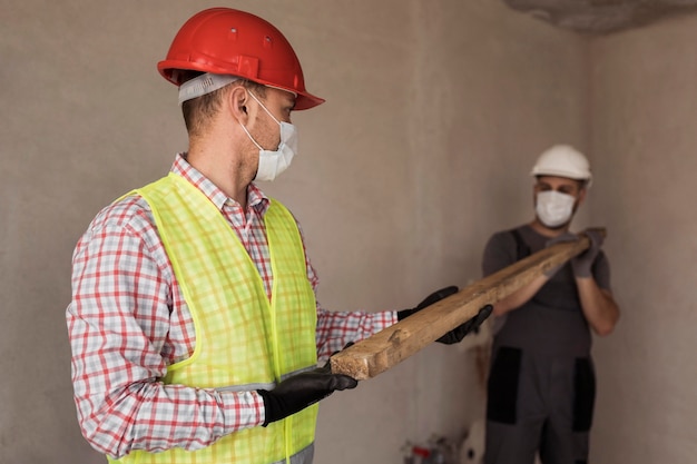 Free Photo medium shot men working with medical masks