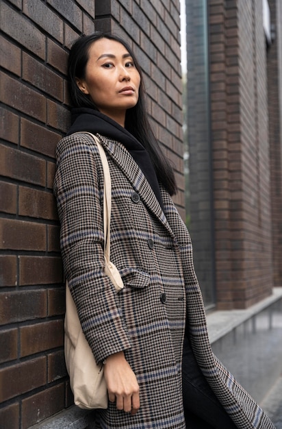 Medium shot model posing near wall