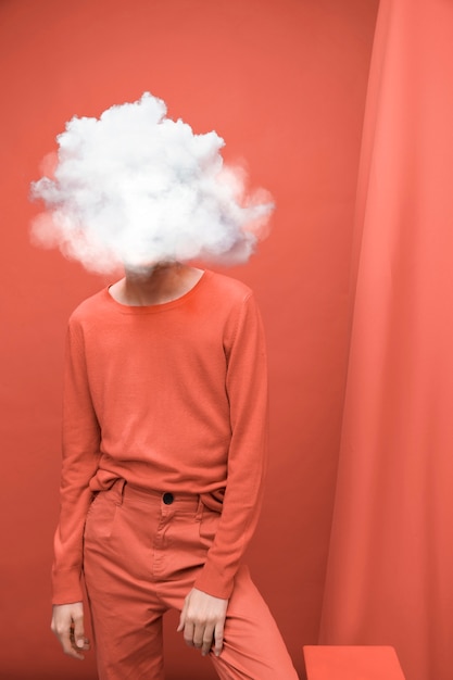 Medium shot model posing with cloud-shaped head