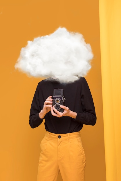 Medium shot model posing with cloud-shaped head