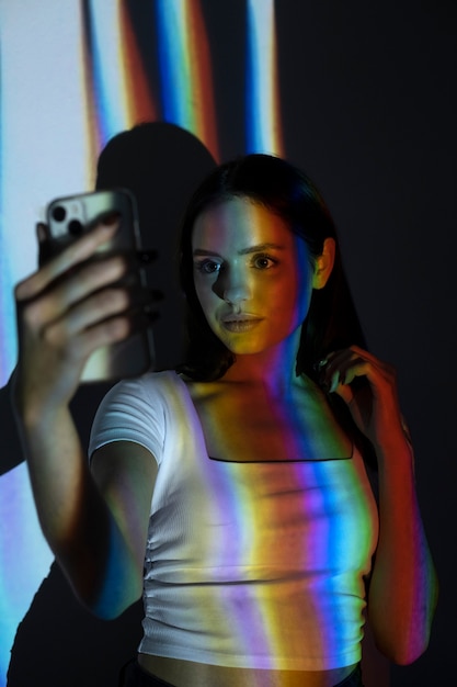 Free photo medium shot model taking selfie with smartphone