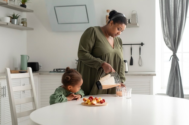 Medium shot mom and girl with healthy food