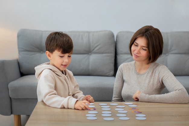 Free photo medium shot mother and boy playing game